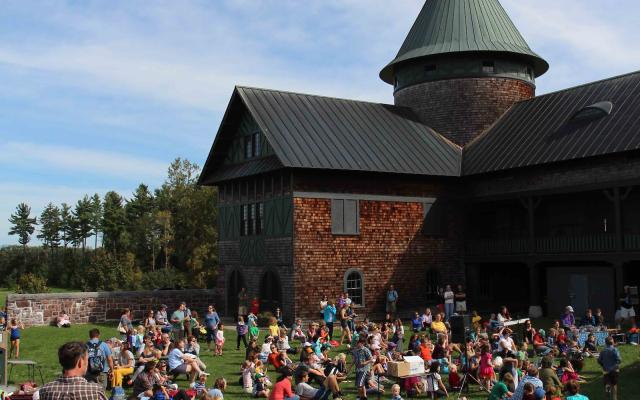 The Farm Barn Courtyard, filled with people watching a concert.