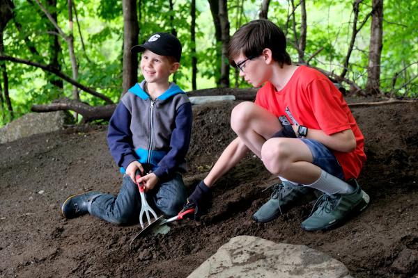 Two students at work cleaning riverbank at Georgia Elementary and Middle School