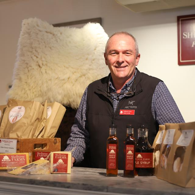 Farm Store staff with cheddar and maple syrup