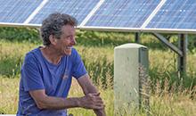 Marshall Webb in front of solar panel field