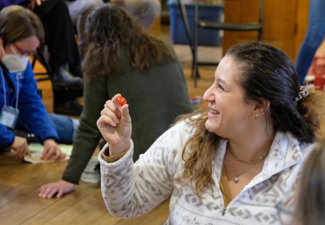 Woman holding a cherry tomato